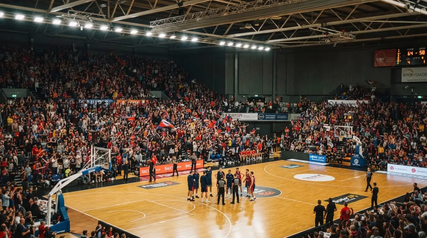 A packed sports hall under floodlights photographed from a long way off